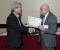 Dr. Nagib Callaos, General Chair, giving Prof. Mitsumasa Zushi the best paper award certificate of the session "Education/Knowledge and Cognitive Science and Technologies". The title of the awarded paper is "Development of a Web Application: Recording Learners’ Mouse Trajectories and Retrieving their Study Logs to Identify the Occurrence of Hesitation in Solving Word-Reordering Problems."